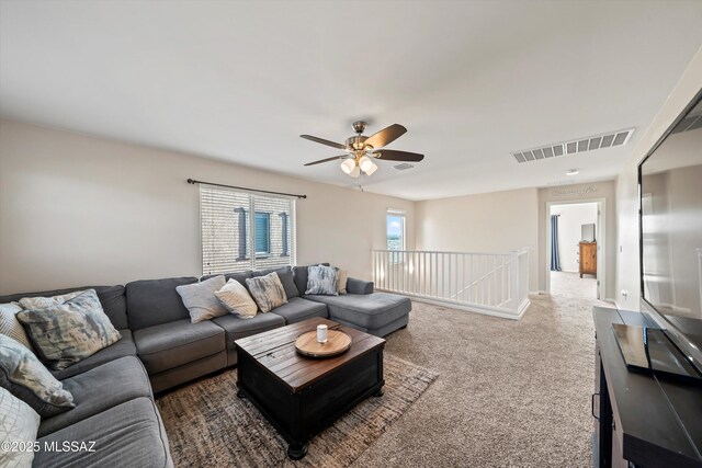 office with a baseboard radiator, light colored carpet, baseboards, and ceiling fan