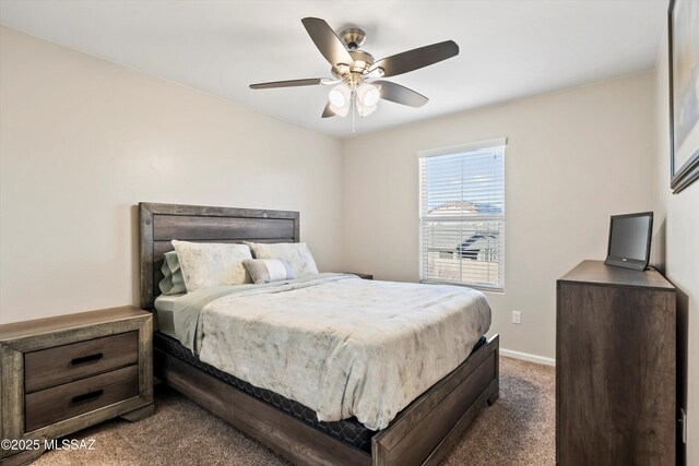 exercise area with baseboards, ceiling fan, and carpet flooring