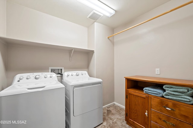 laundry area featuring visible vents, baseboards, independent washer and dryer, and laundry area