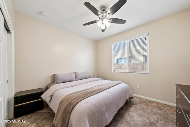 tiled bedroom featuring a closet, ceiling fan, and baseboards