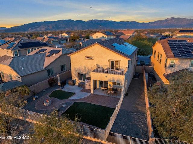 aerial view at dusk featuring a mountain view and a residential view