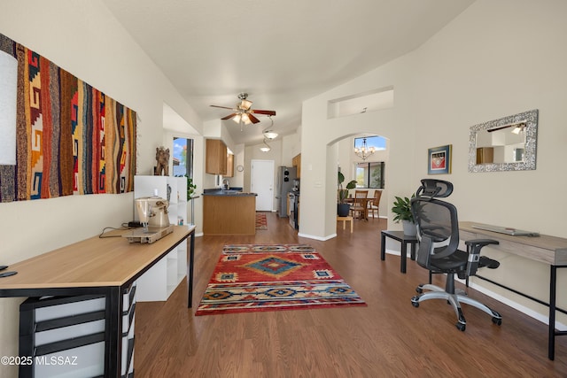 office featuring baseboards, arched walkways, dark wood-style flooring, and ceiling fan with notable chandelier