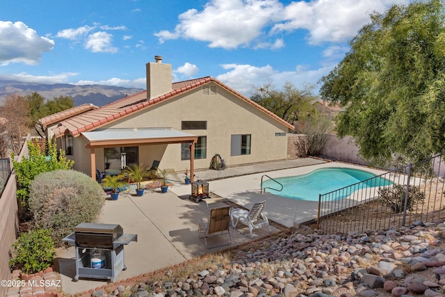 view of swimming pool with a fenced in pool, a patio, grilling area, a fenced backyard, and a fire pit