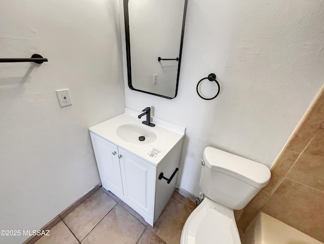 bathroom with vanity, toilet, and tile patterned floors