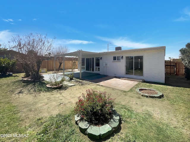 rear view of property with a patio, a yard, and a fenced backyard