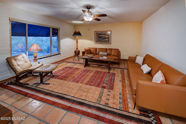 tiled living room with brick wall and ceiling fan