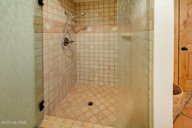 full bath featuring tiled shower
