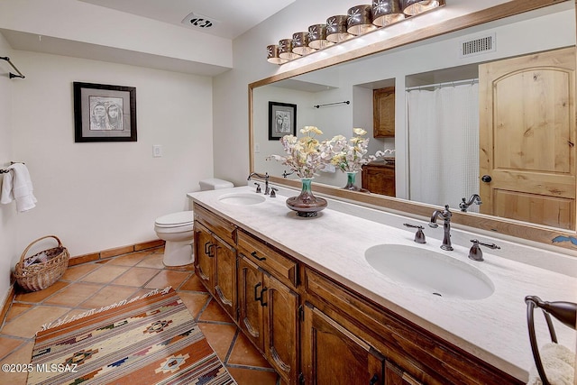 full bathroom featuring visible vents, a sink, toilet, and tile patterned flooring