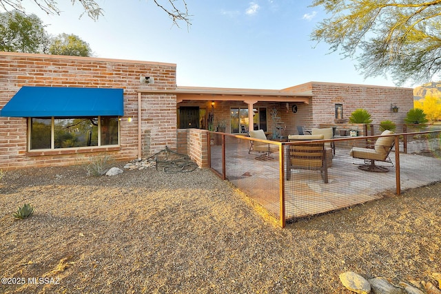 back of house with a patio area and brick siding