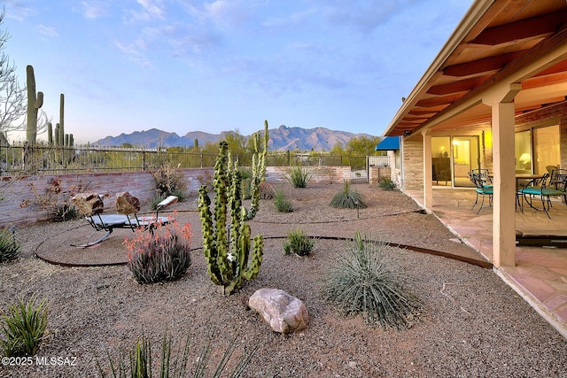 view of yard featuring a fenced backyard, a patio, and a mountain view