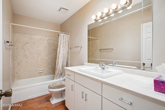 full bath featuring toilet, shower / tub combo, wood finished floors, vanity, and visible vents