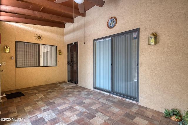 exterior space featuring a patio area and stucco siding