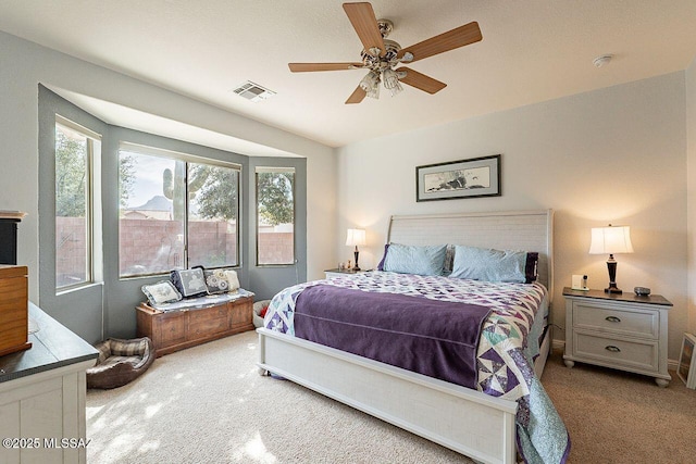 bedroom with carpet floors, ceiling fan, and visible vents