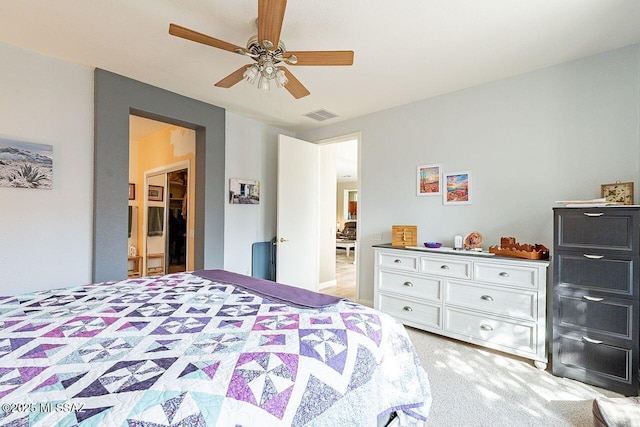 bedroom with light colored carpet, ceiling fan, and visible vents