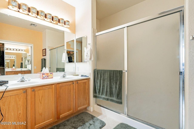 full bath featuring a shower stall, visible vents, and a sink