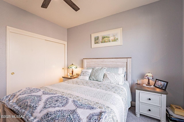 bedroom with a ceiling fan and carpet