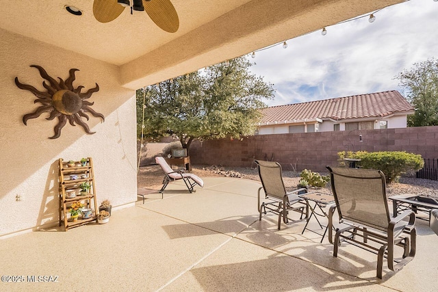 view of patio / terrace with fence private yard, outdoor dining area, and ceiling fan