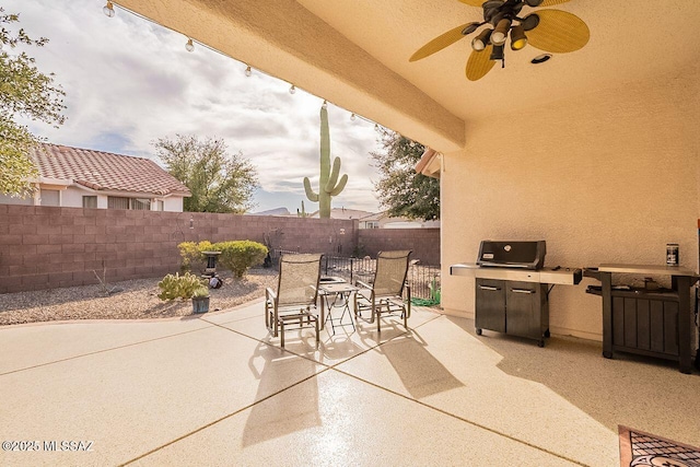 view of patio featuring a ceiling fan, outdoor dining space, and a fenced backyard