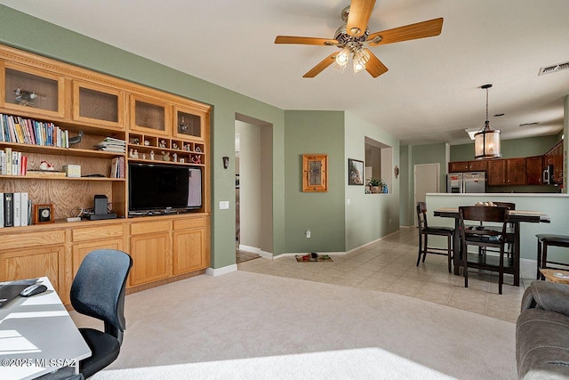 living area with light tile patterned floors, light colored carpet, a ceiling fan, baseboards, and visible vents