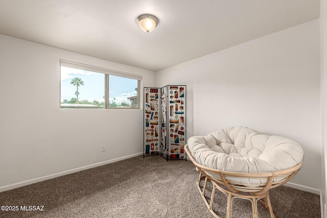 living area featuring carpet floors and baseboards