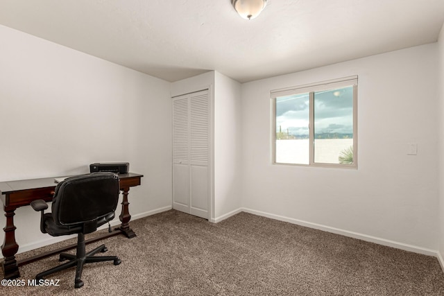 carpeted home office with baseboards