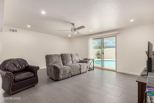 living area featuring ceiling fan, recessed lighting, visible vents, and baseboards