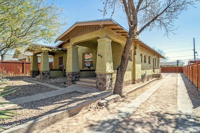 exterior space with fence and stucco siding