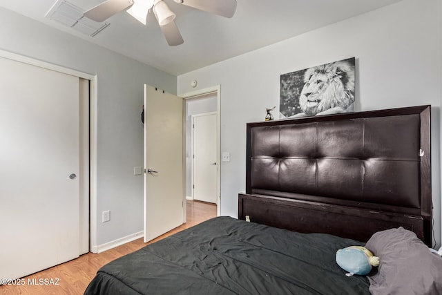 bedroom with wood finished floors, baseboards, ceiling fan, and visible vents