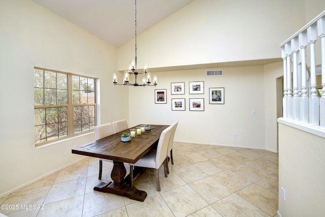 dining area with light tile patterned floors, a chandelier, visible vents, high vaulted ceiling, and baseboards