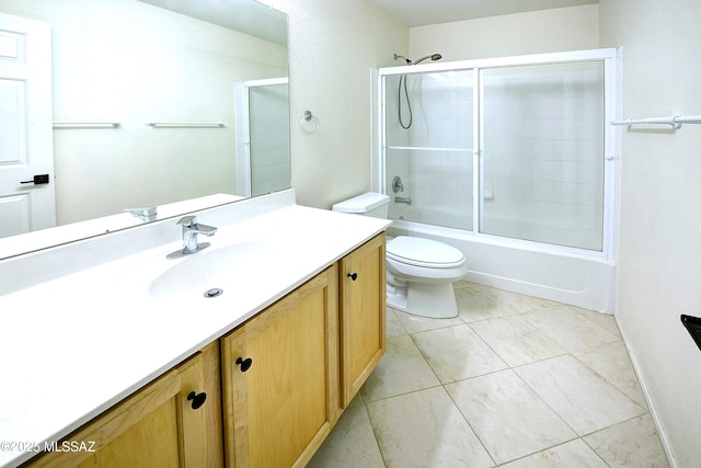 full bath featuring toilet, tile patterned floors, combined bath / shower with glass door, and vanity