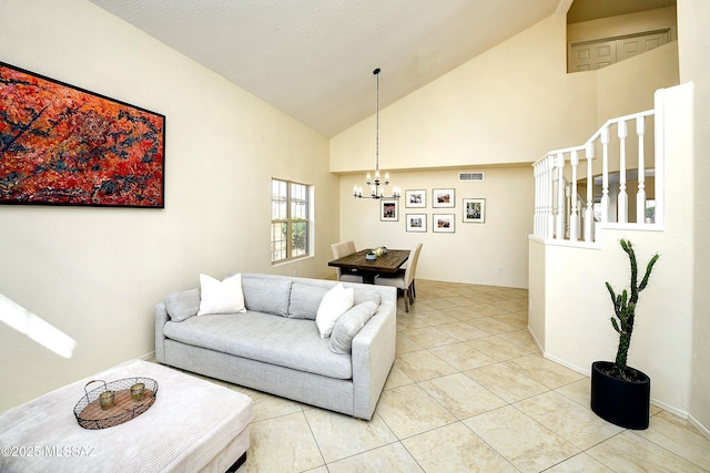 living area with lofted ceiling, light tile patterned floors, visible vents, and an inviting chandelier