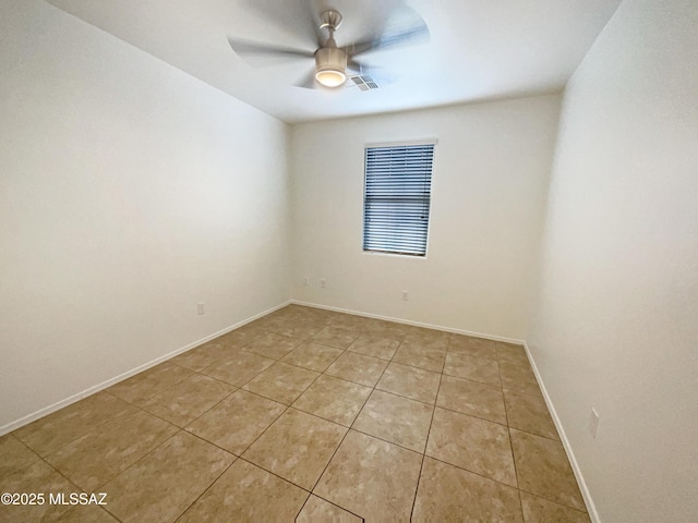 empty room with light tile patterned floors, ceiling fan, visible vents, and baseboards