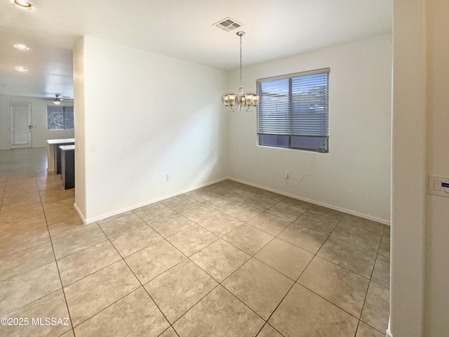 spare room with ceiling fan with notable chandelier, visible vents, baseboards, and light tile patterned floors