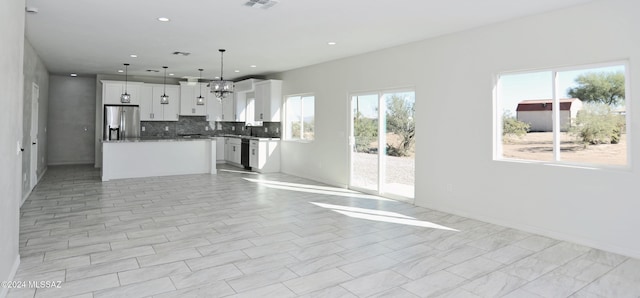 kitchen with dishwasher, open floor plan, white cabinetry, stainless steel refrigerator with ice dispenser, and backsplash