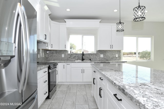 kitchen with a sink, hanging light fixtures, stainless steel fridge with ice dispenser, electric range oven, and tasteful backsplash