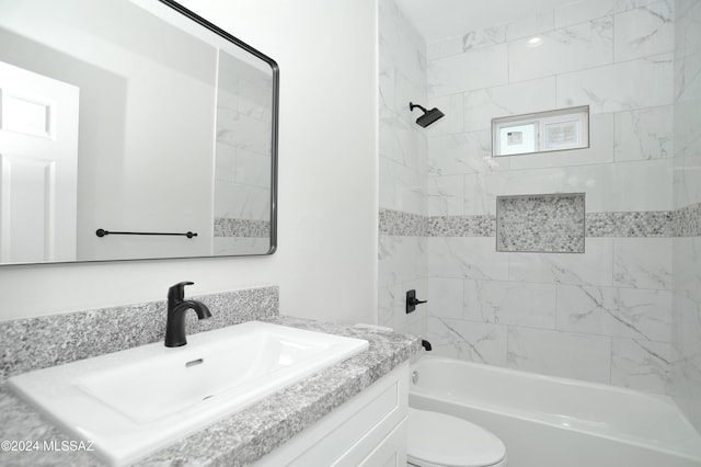 bathroom with shower / washtub combination, vanity, and toilet