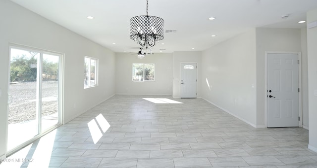 unfurnished dining area featuring recessed lighting, a notable chandelier, and baseboards