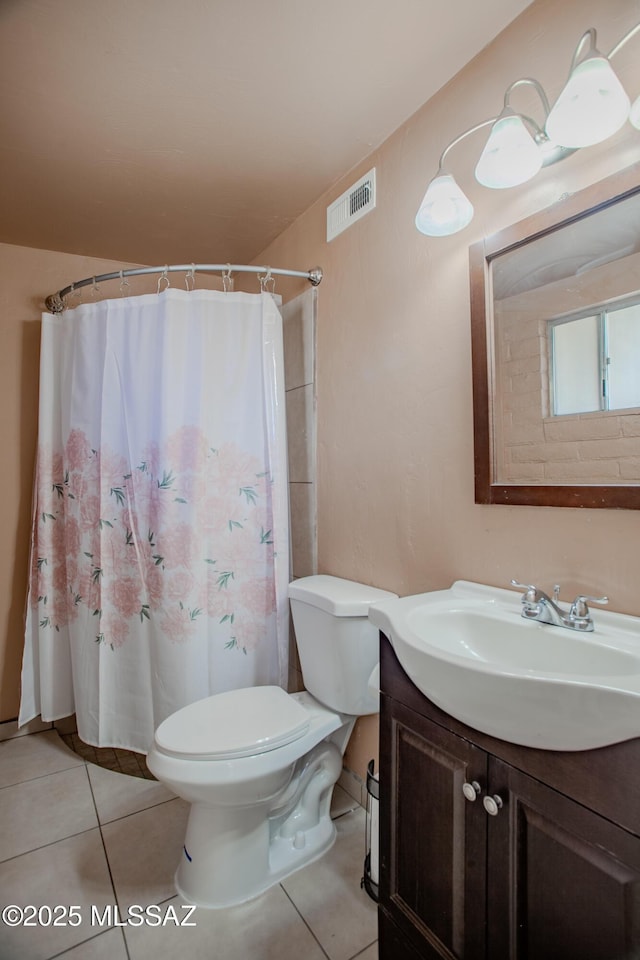 bathroom featuring toilet, a shower with shower curtain, vanity, visible vents, and tile patterned floors