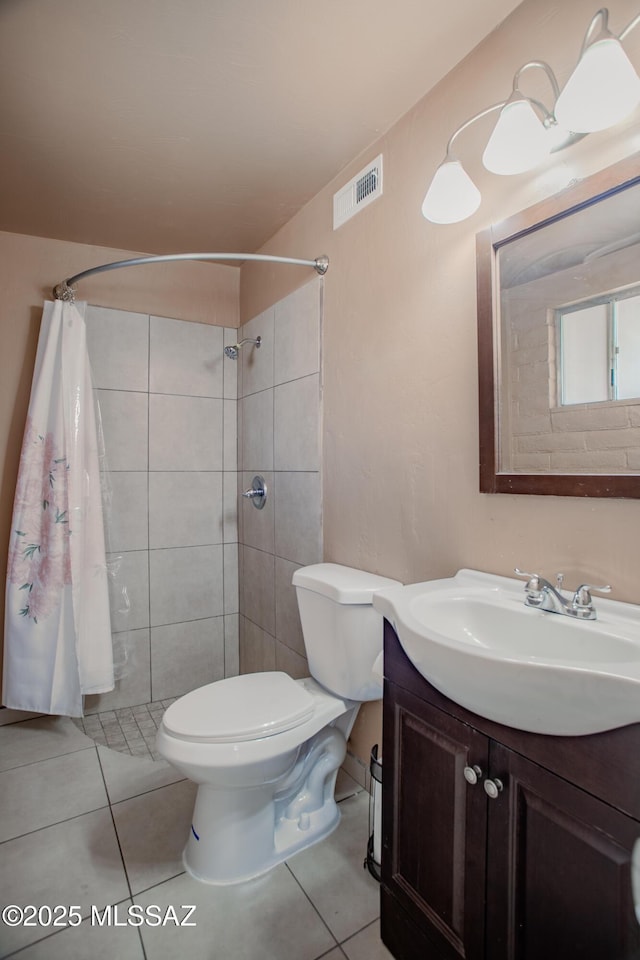 bathroom with visible vents, a tile shower, toilet, and tile patterned floors