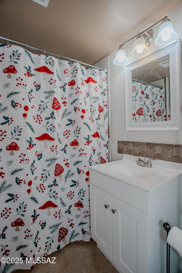 full bath with vanity, a shower with shower curtain, and tile patterned floors