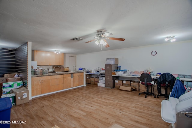 kitchen with a textured ceiling, ceiling fan, light brown cabinets, visible vents, and light wood-style floors