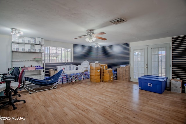 office with french doors, visible vents, ceiling fan, and wood finished floors