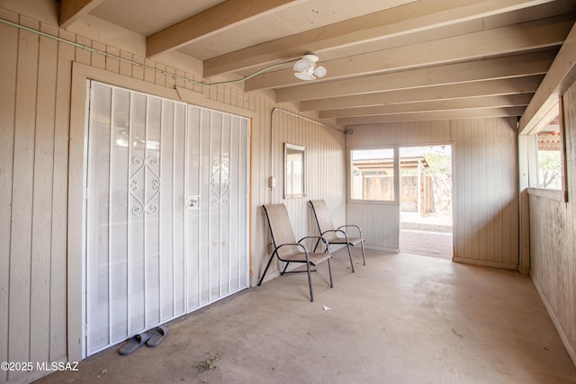 unfurnished sunroom with beamed ceiling