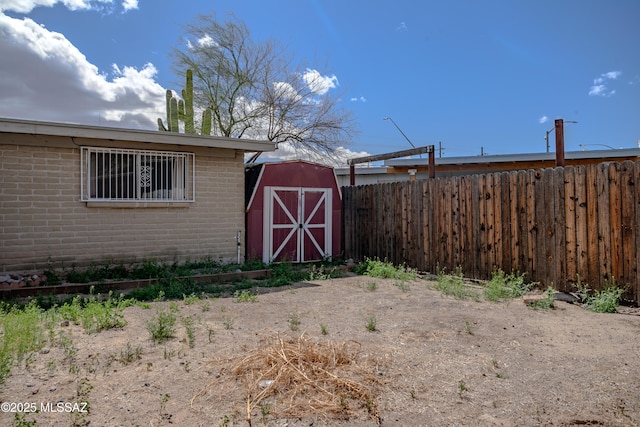 view of shed featuring fence