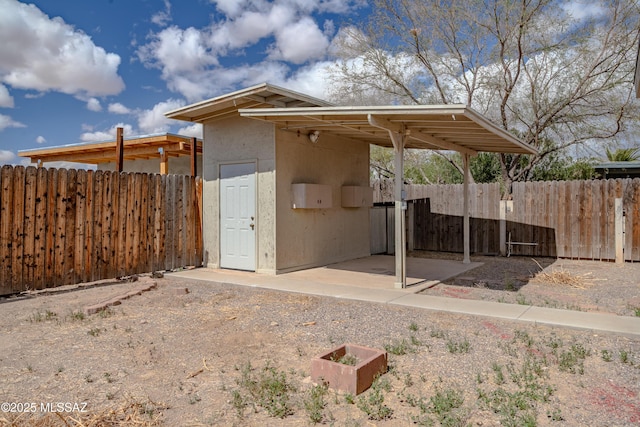 view of outbuilding featuring fence