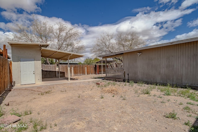 view of yard with fence and an outdoor structure