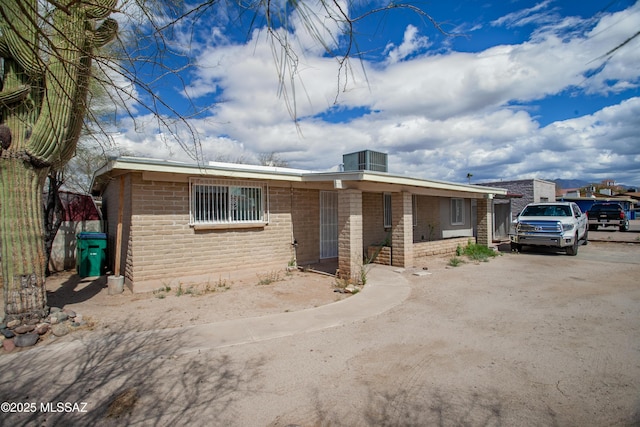 ranch-style house with concrete driveway and brick siding