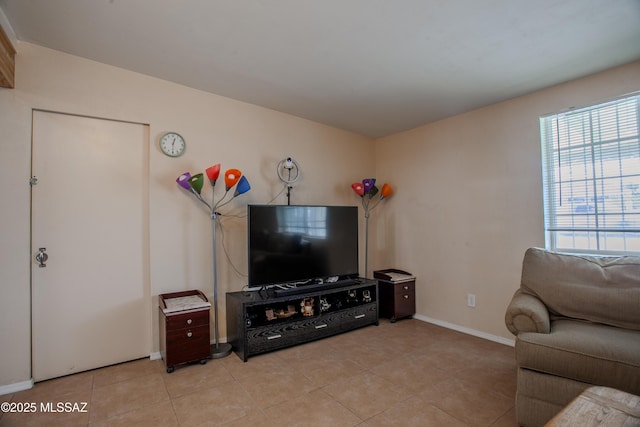 living room featuring light tile patterned flooring and baseboards