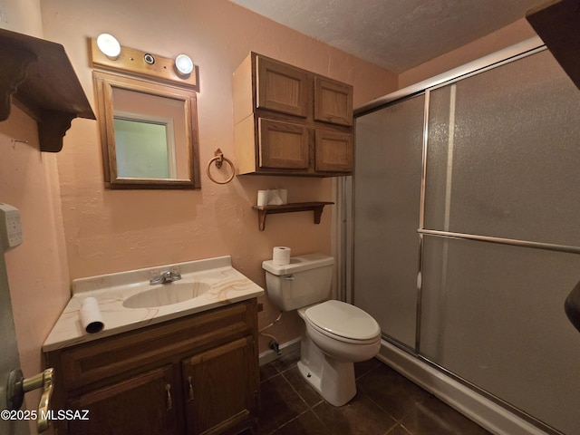 bathroom with toilet, a stall shower, vanity, tile patterned flooring, and baseboards