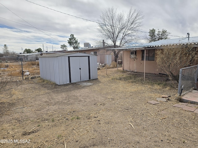 exterior space featuring cooling unit, fence, an outdoor structure, and a shed